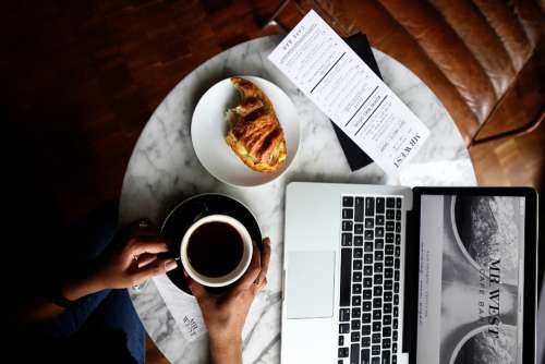 breakfast pastry coffee laptop table