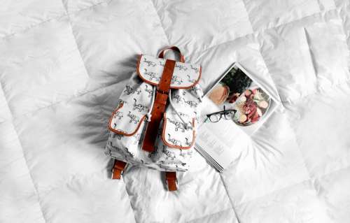 white bed bag backpack book