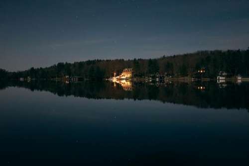 lake water reflection houses night