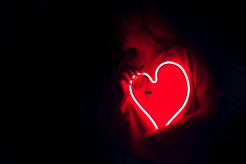red neon heart light woman