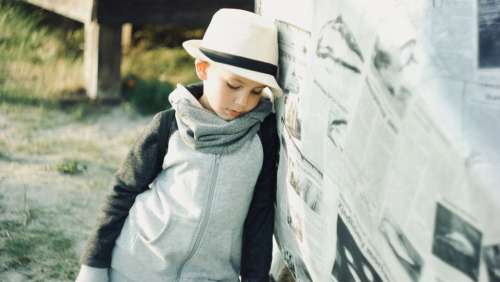 young child thinking pensive hat