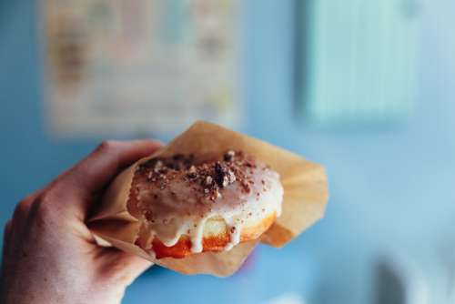 man holding donut doughnut pastry