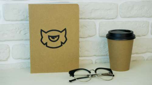 coffee glasses book notepad white wall