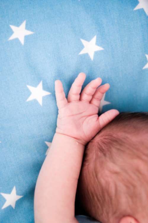 small baby hand blue stars