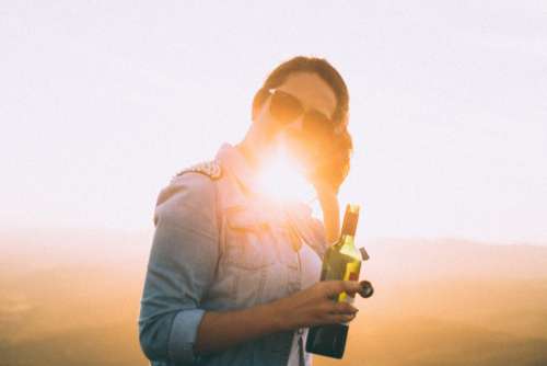 woman wine sunglasses sun flare lens