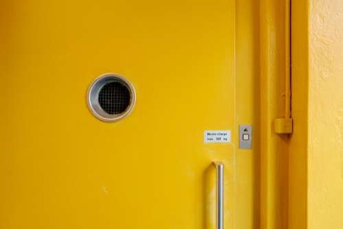yellow door hole wall