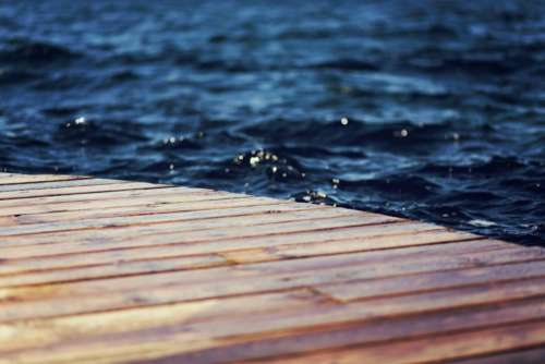 wood dock water waves ripples