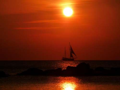 sunset sailboat water ocean sea