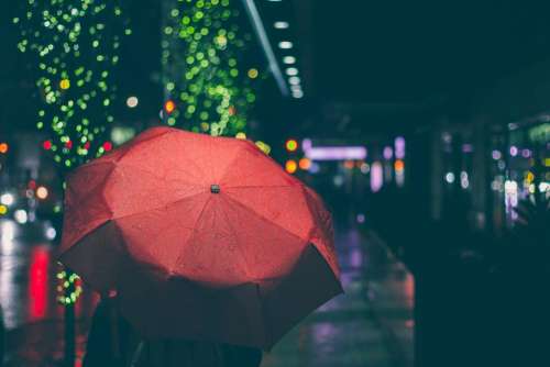 red umbrella raining night dark