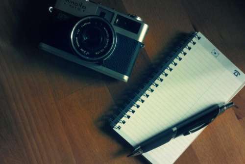 camera notepad pen photography office