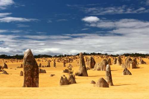 sand rock formation trees cloud