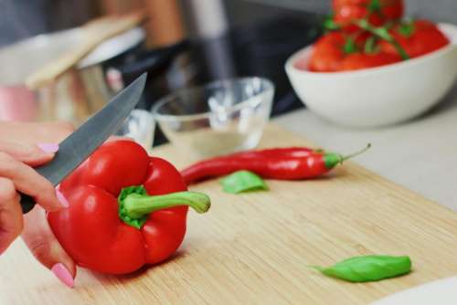 red peppers vegetables cooking cutting board knife