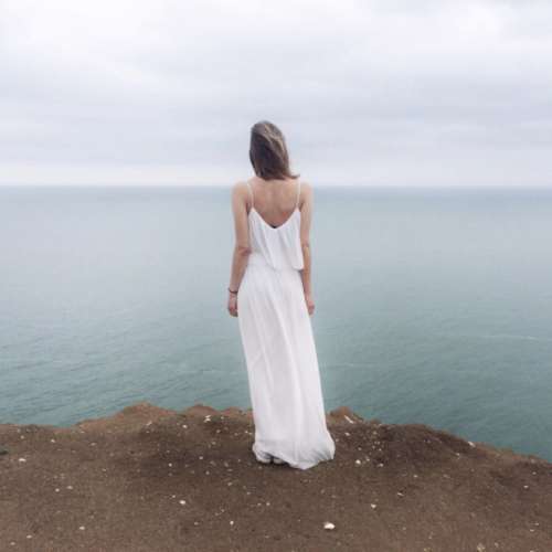 mystery woman cliff sea ocean