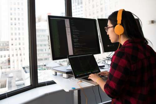 woman developer office monitor dual-screen