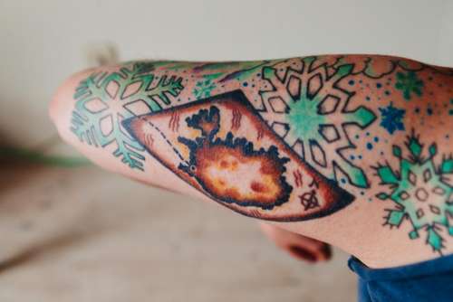 tattoo ink snowflake arm skin