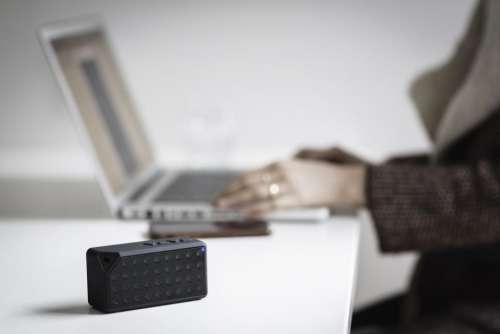 people blur speaker laptop table