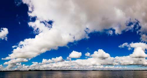 blue sky clouds lake water