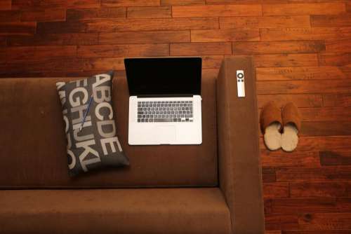 macbook laptop apple remote sofa