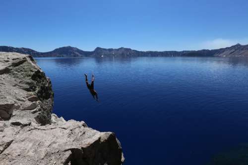 man diving lake water cold