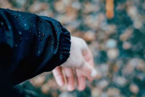 people hands jacket water droplets