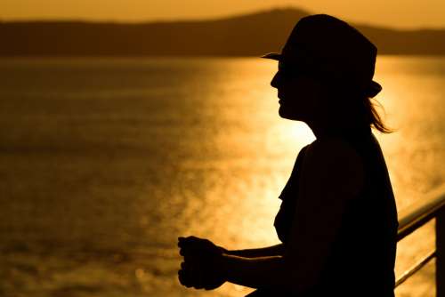 woman sunset water silhouette happy