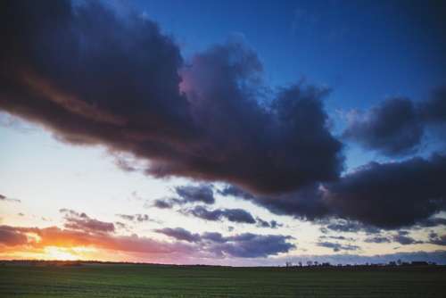 sunset dusk sky clouds field