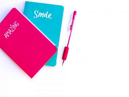 pink blue notebook pen write