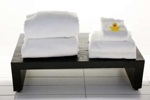 spa white towels tiles bench