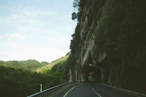 sky road tunnel winding hills