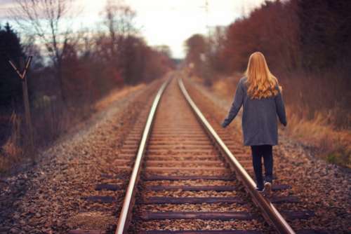 young girl tracks railway train