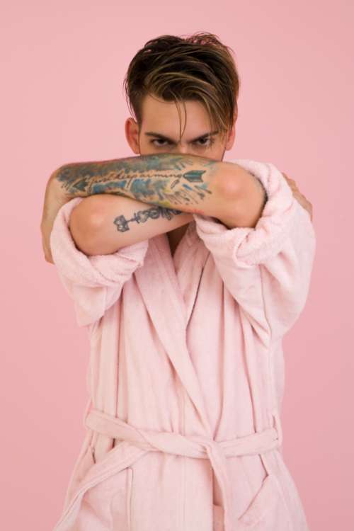 man model pink bathrobe tattoo pink background