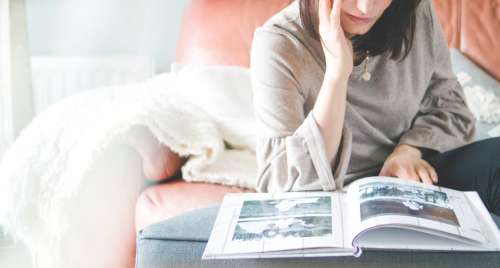 woman reading living room book magazine