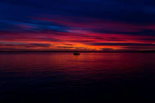 sunset dusk sky clouds boat