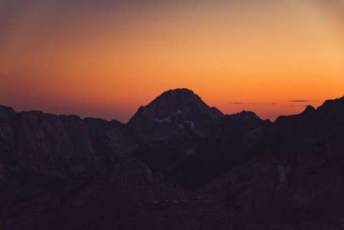 mountains peaks cliffs sunset dusk