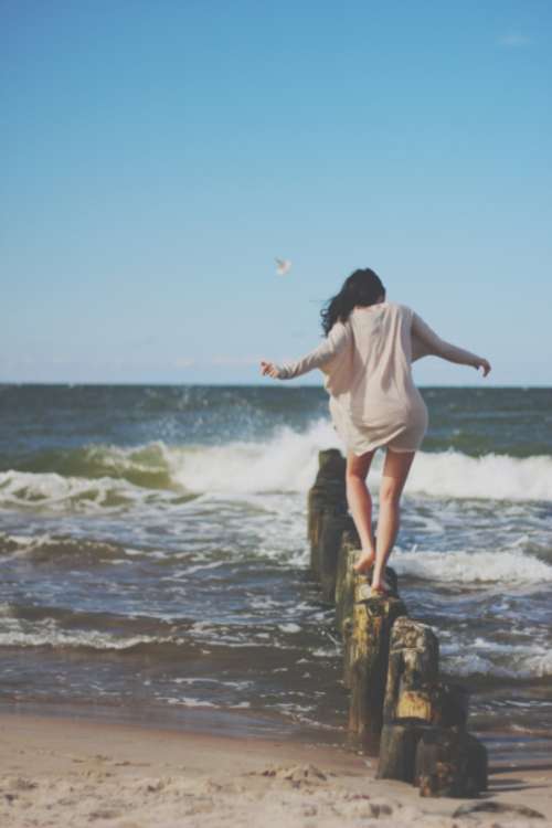 woman stepping ocean sea water