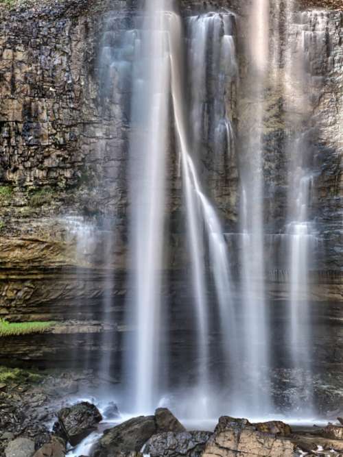 waterfall rocks water rural cliff