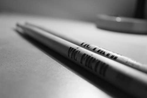 black and white drumsticks wooden sticks blur