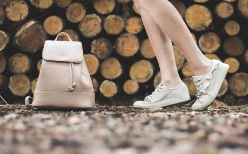 woman white shoes handbag stack