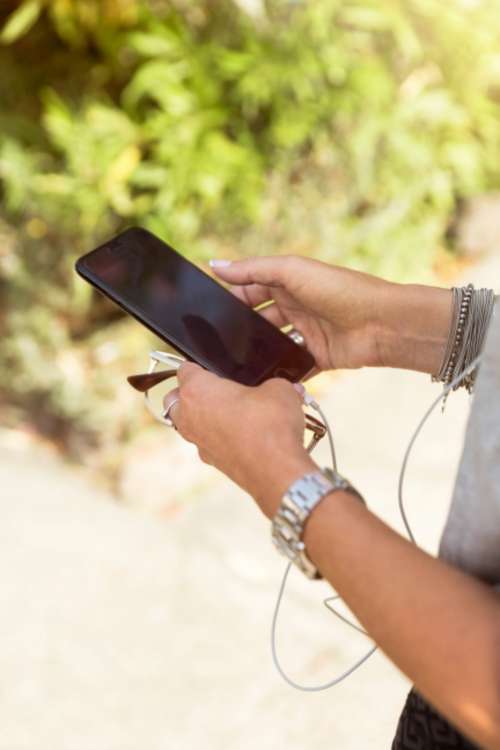 woman holding mobile phone working developer