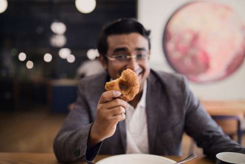 businessman holding donut food dinner