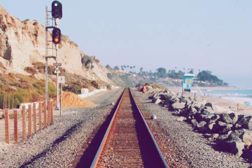 train tracks pebbles rocks sand beach