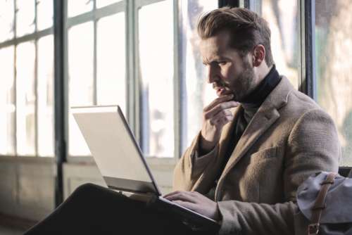 man deep thinking computer concerned