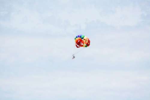 colorful parachute blue sky clouds