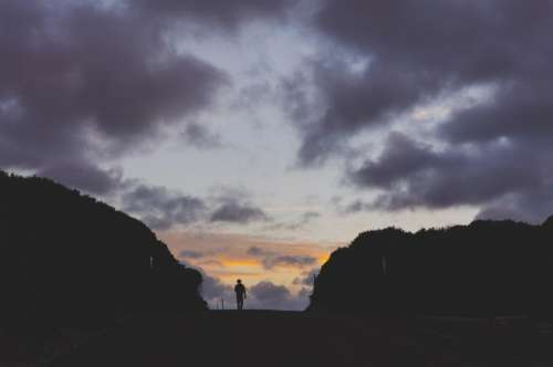 people walking alone silhouette sunset