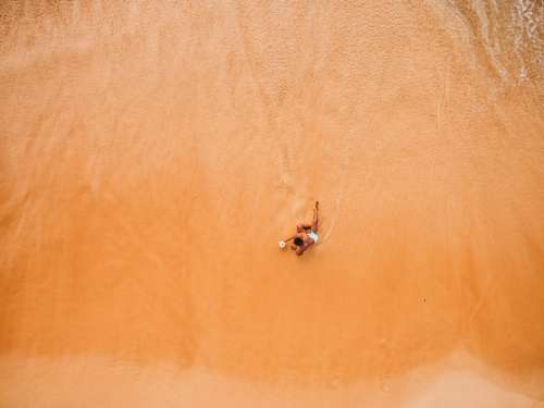 beach aerial man coast ocean