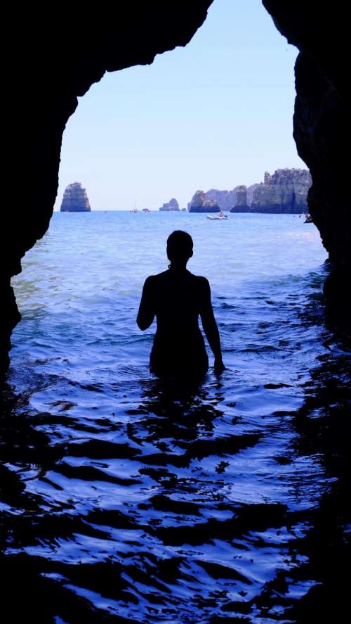 silhouette woman alone swimming sea