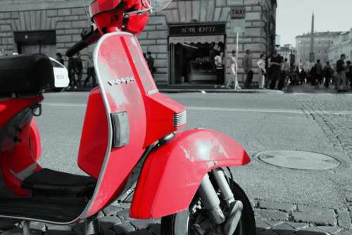 red vespa scooter moped street