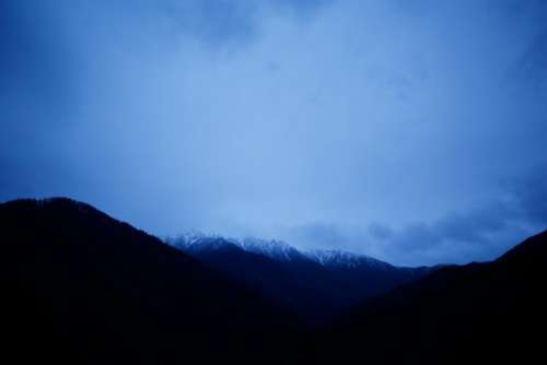 dark mountain valley blue sky