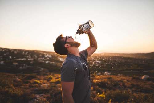 guy man drinking water water bottle