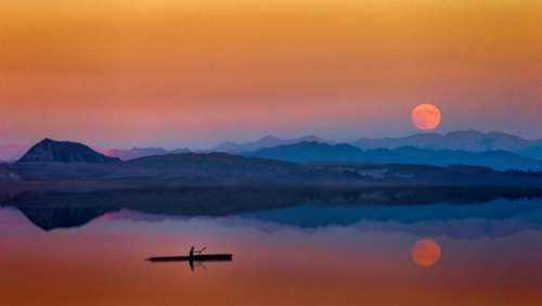 man canoe sunset moon dark